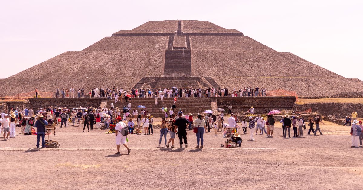 Visitors exploring the iconic Pyramid of the Sun at Teotihuacán, a historic landmark in Mexico.